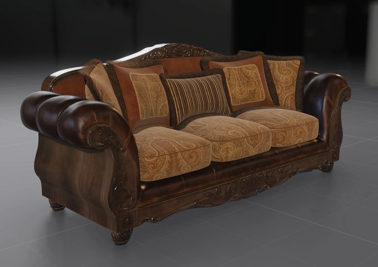 A carved wooden sofa with dark leather arms and paisley cushions.